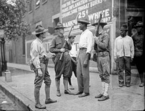 National Guardsmen surround man on street, 1919 Photograph by Jun Fujita Chicago History Museum, ICHi-065478